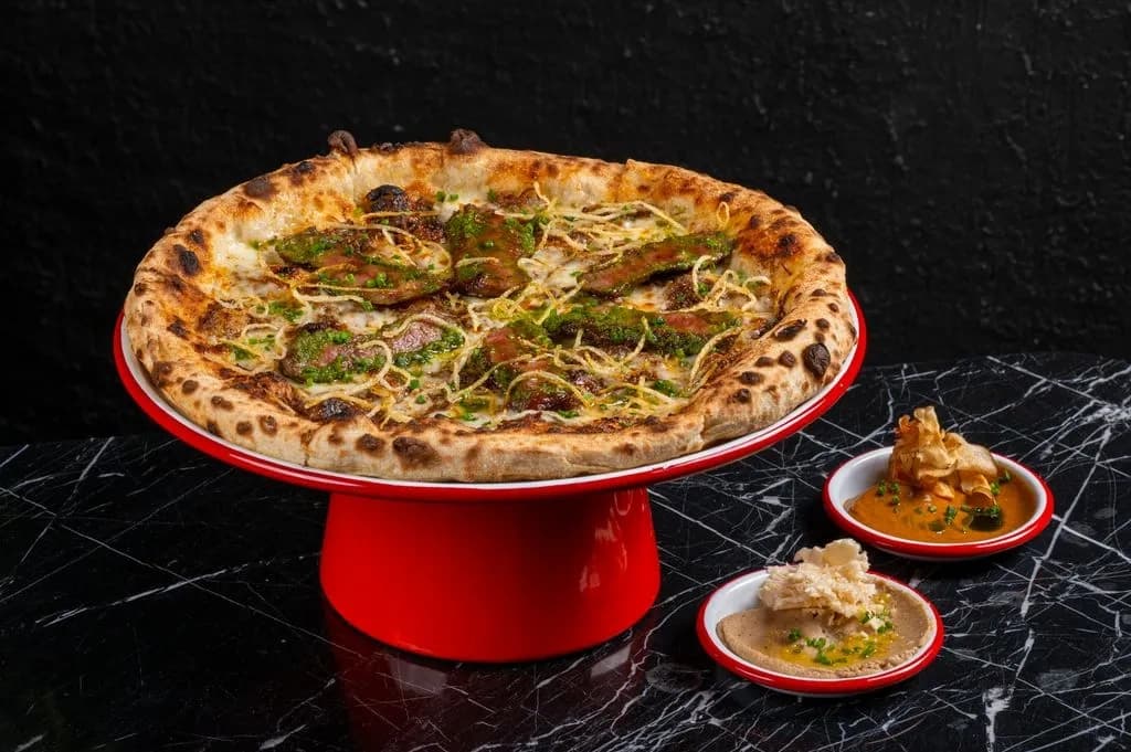 Gourmet beef pizza with steak, truffle honey, cheese, and thin fries