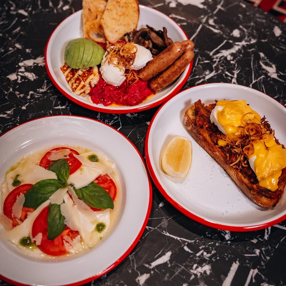Beautifully plated Italian appetizers and fresh ingredients on rustic wooden table